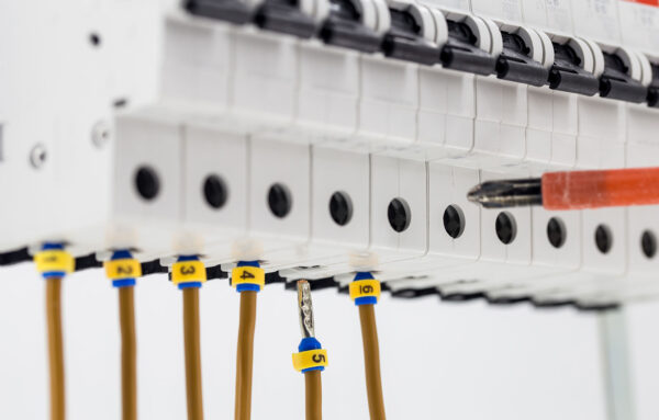 Photo of a screwdriver accessing an electrical panel.